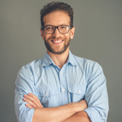 Man with glasses smiling with arms crossed Man with glasses smiling with arms crossed