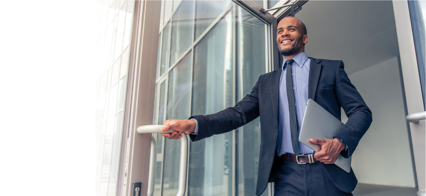 man holding door open leaving with a smile on his face